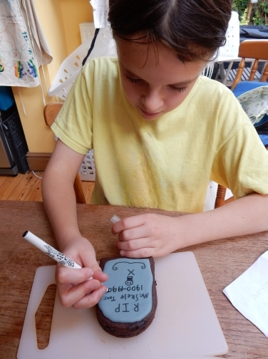 child writing on cookies